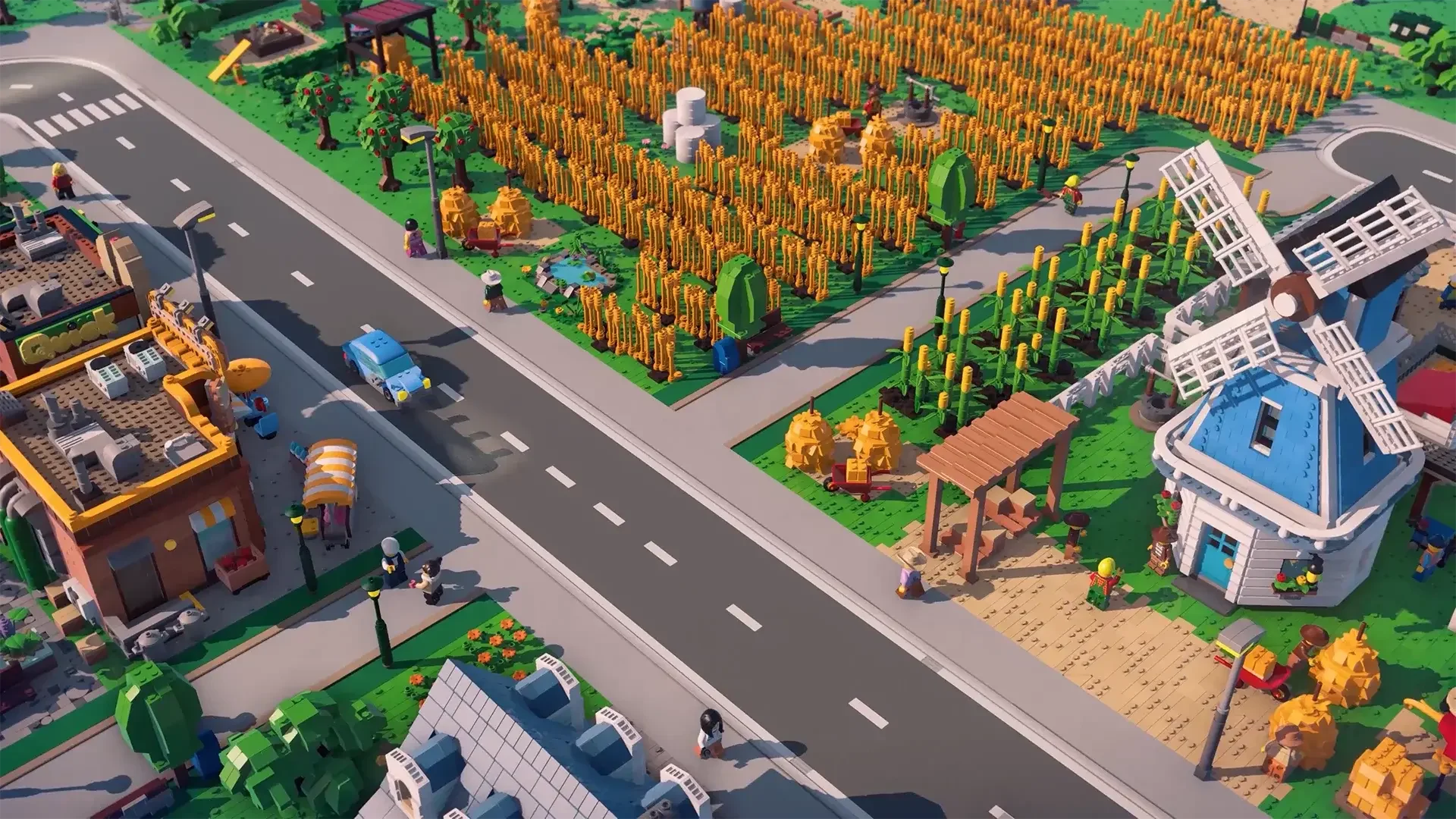 Official LEGO Skylines farm scene with wheat fields, a windmill, road, and citizens